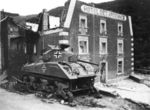 1945, January, Esch-sur-Sure. M4A3 from 5.Fallschirmjäger Division destroyed in front of Hotel des Ardennes.jpg