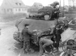 Crew of medium M4 Sherman tank apply a layer of cement to the frontal armor of the tank in order to increase. Gelsenkirchen, Germany, March 19, 1945.jpg