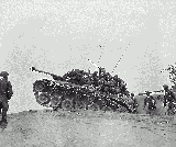 Men of the 9th Infantry Regiment man an M-26 tank to await an enemy attempt to cross the Naktong River